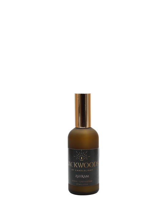 Room & Linen Spray bottle labeled 'Backwoods by Candlelight Ashram' on a white background