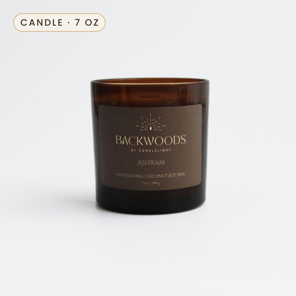 Ashram 7 oz candle in an amber glass jar with a gold foil label