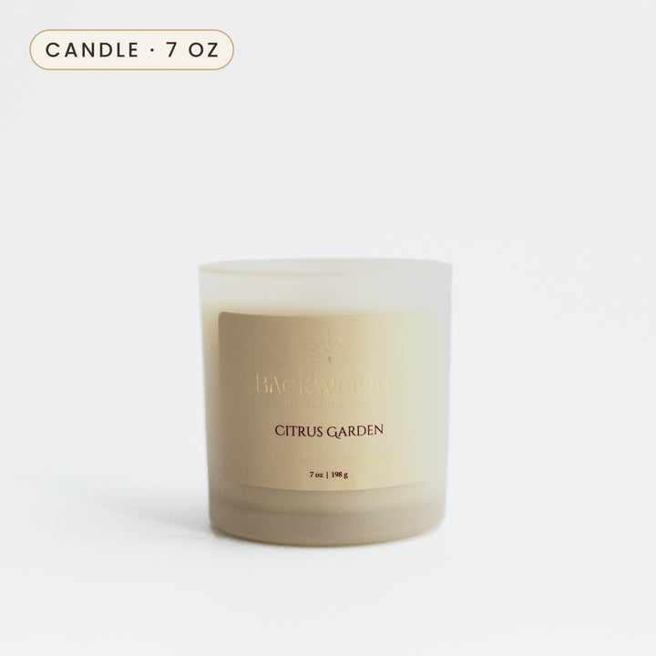 Citrus Garden 7 oz candle in a frosted ivory jar with a gold foil label