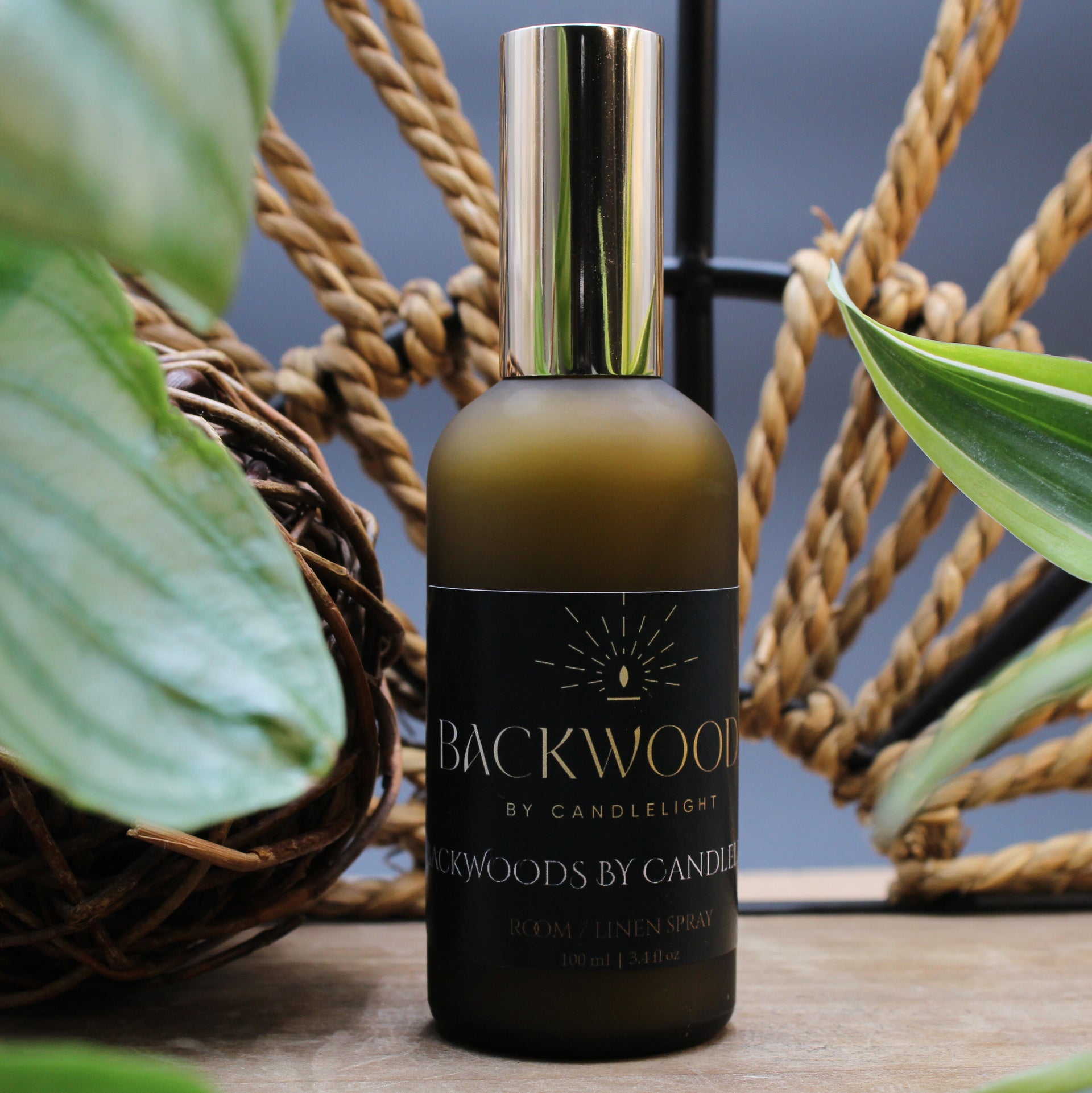 Room spray bottle labeled 'Backwoods by Candlelight' on a white background