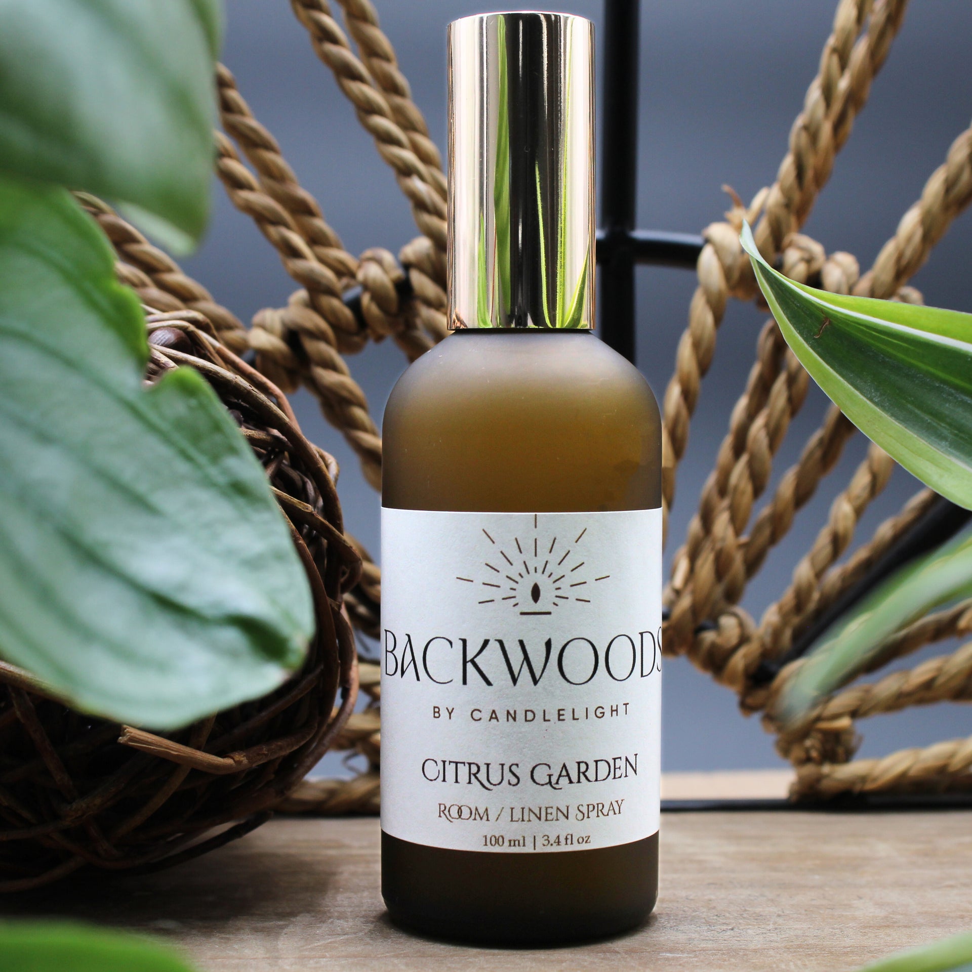 Room spray bottle labeled 'Backwoods by Candlelight' on a white background