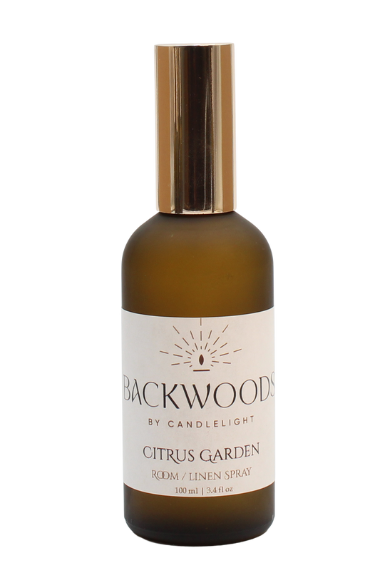 Room spray bottle labeled 'Backwoods by Candlelight Citrus Garden' on a white background