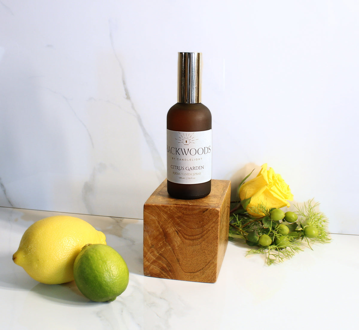 Room spray bottle labeled 'Backwoods by Candlelight' on a white background