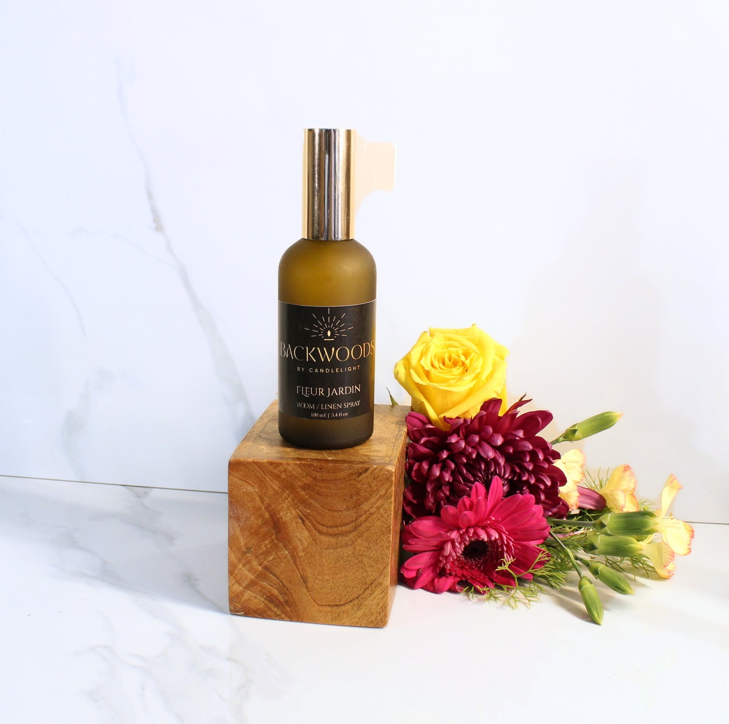 Room spray bottle labeled 'Backwoods by Candlelight' on a white background