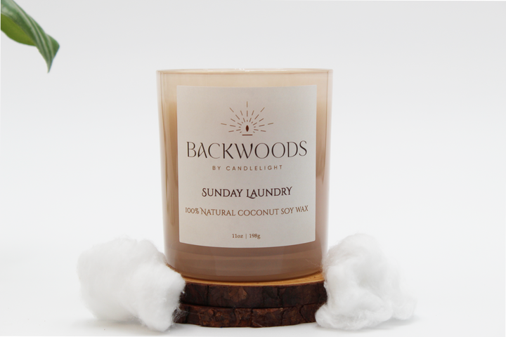 Backwoods By Candlelight all natural candle, non-toxic candle. Sunday Laundry front label with cotton balls, leaf, wooden wick and candle coaster.