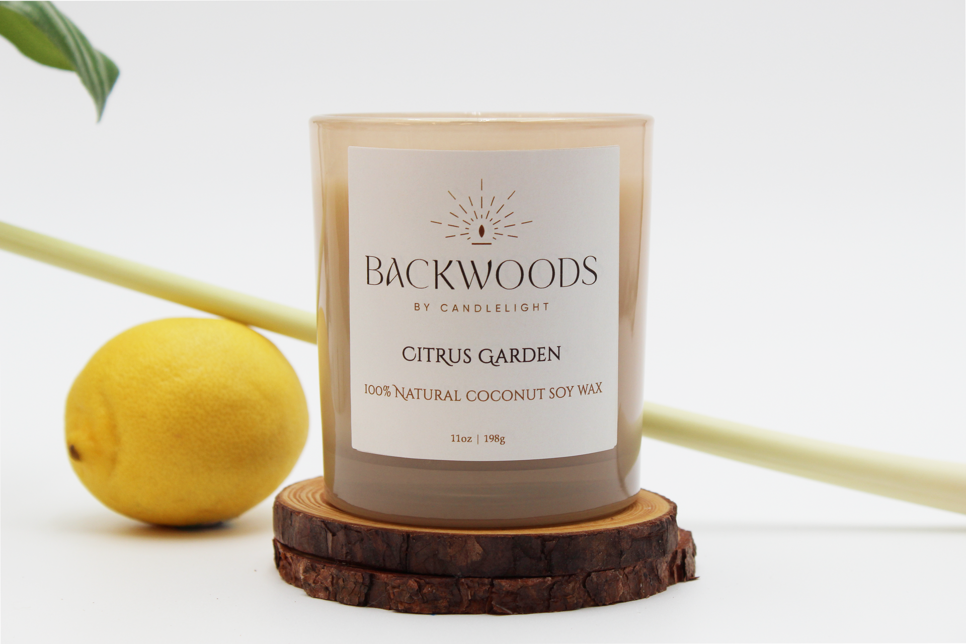 Backwoods By Candlelight all natural candle, non-toxic candle. Citrus Garden front label with lemon, leaf, wooden wick and candle coaster.