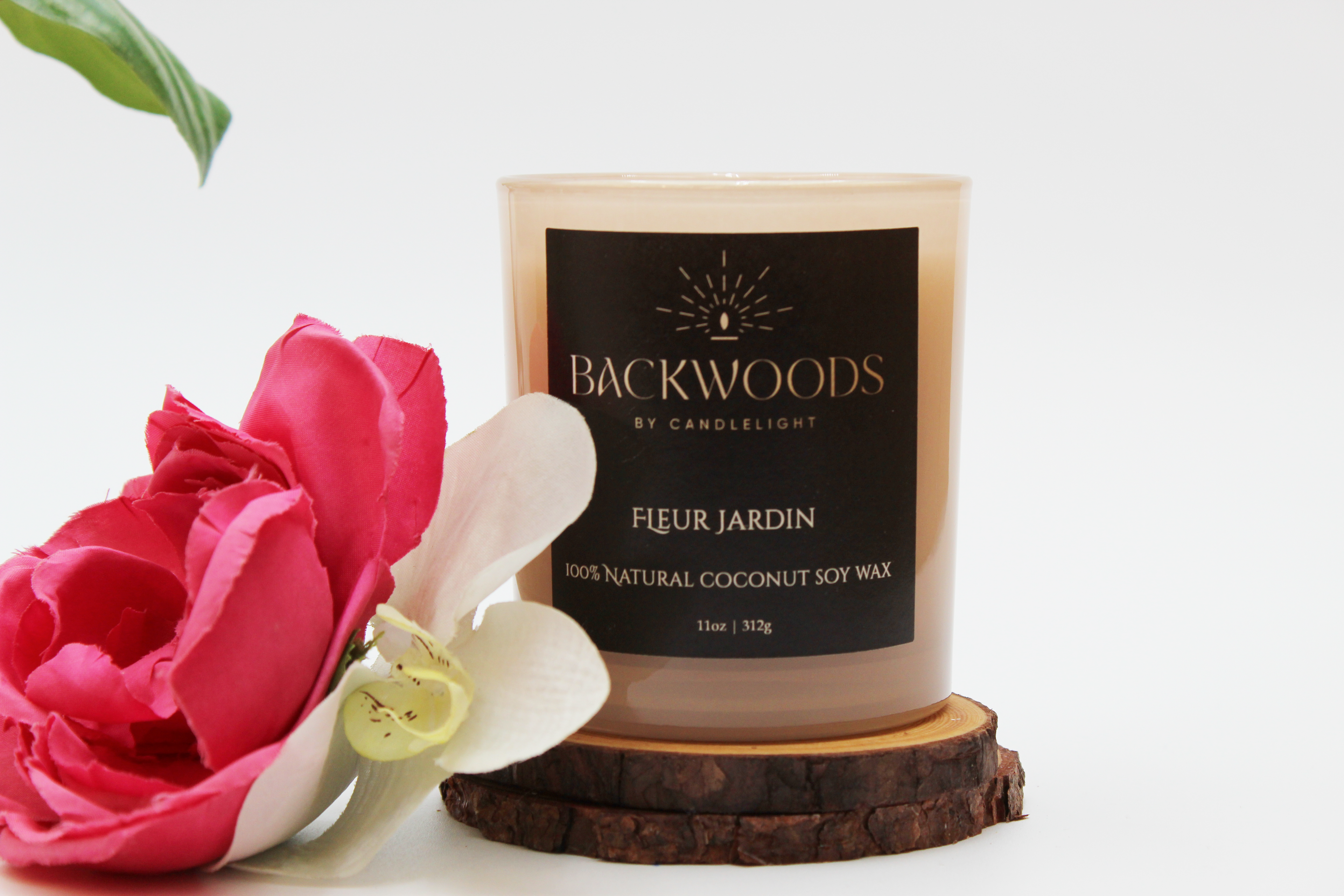 Backwoods By Candlelight all natural candle, non-toxic candle. Fleur Jardin front label with flowers, leaf, wooden wick and candle coaster.