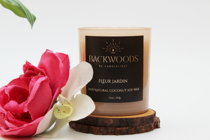 Backwoods By Candlelight all natural candle, non-toxic candle. Fleur Jardin front label with flowers, leaf, wooden wick and candle coaster.